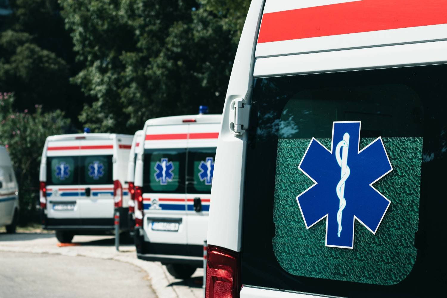 Row of white ambulances parked outdoors, representing emergency medical services available in and around Kalkan.