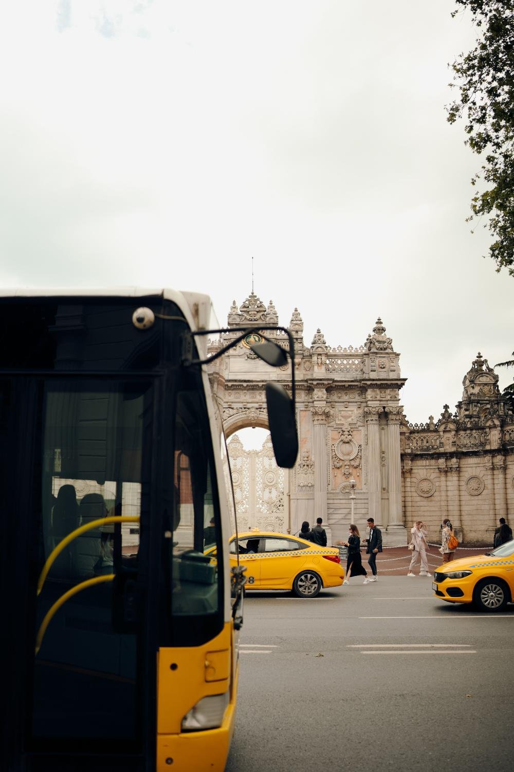 Yellow taxis and a localbus, illustrating transport options.