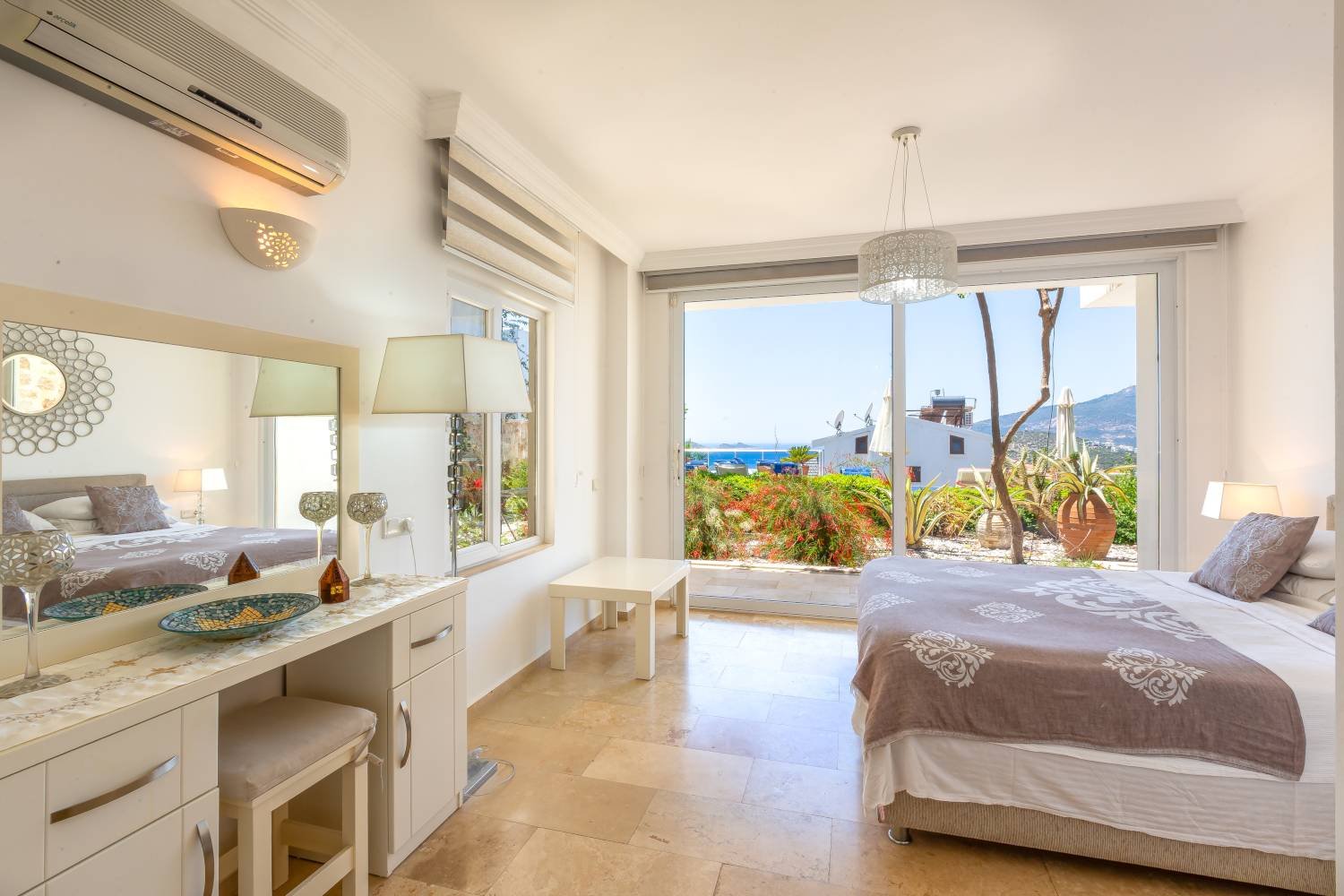 Bright bedroom at Kalkan Limon Apartment with terrace access, sea views and modern furnishings.