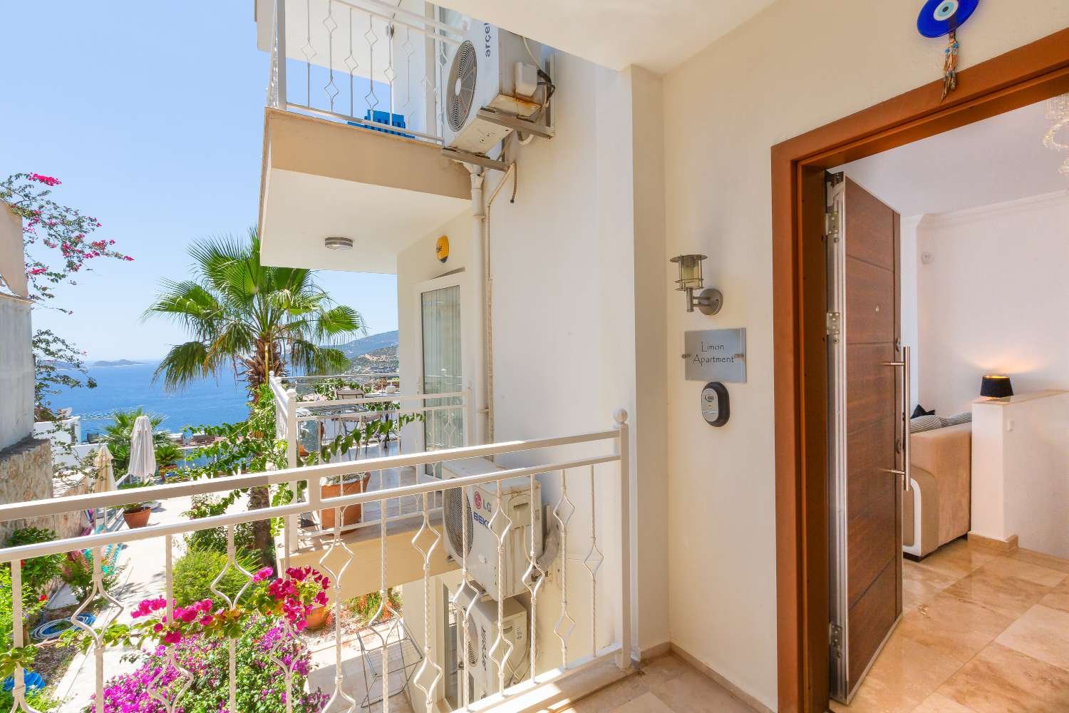Entrance to Kalkan Limon Apartment with balcony, sea views and decorative railings.