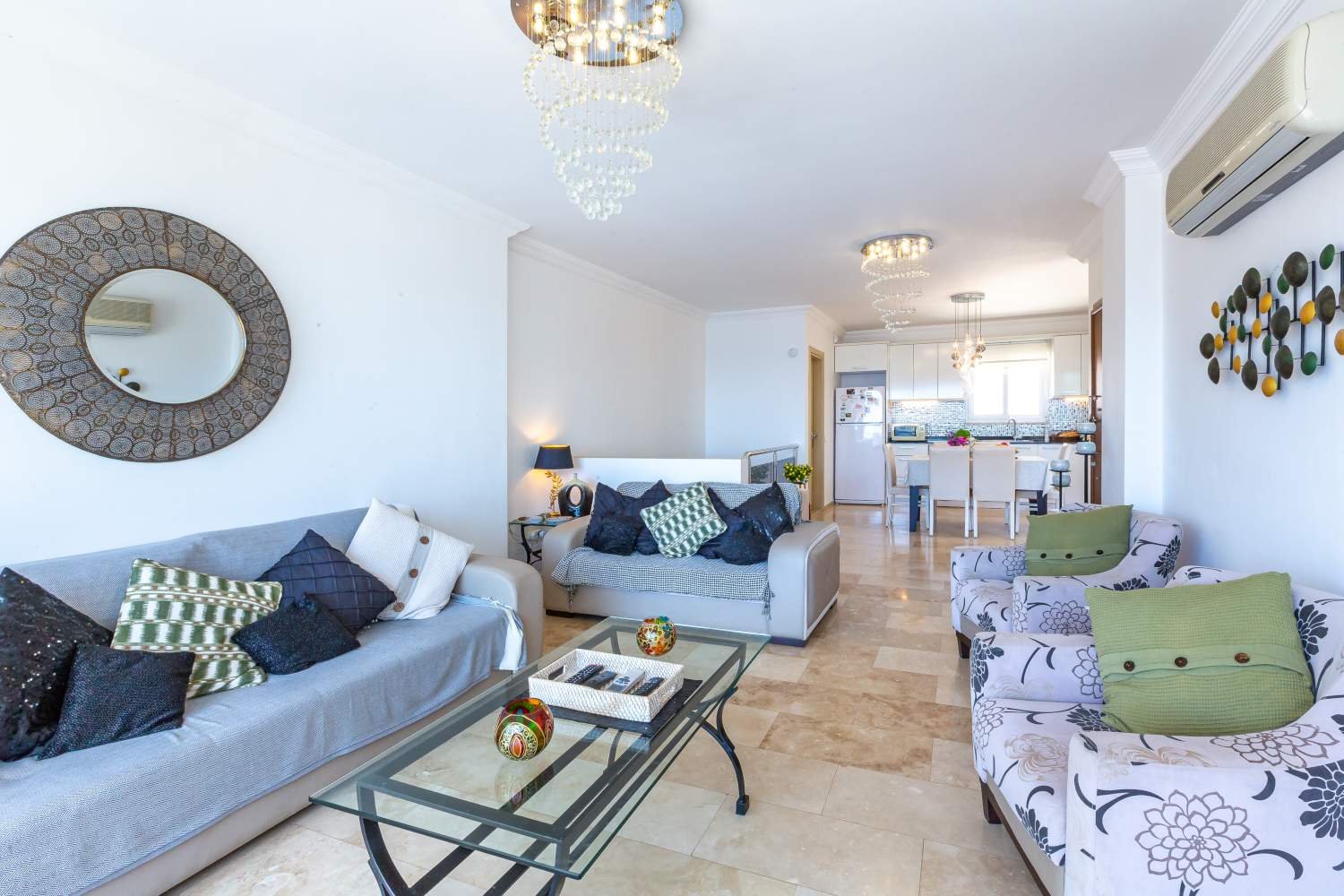 Air conditioning unit in the lounge at Kalkan Limon Apartment above modern seating and décor.