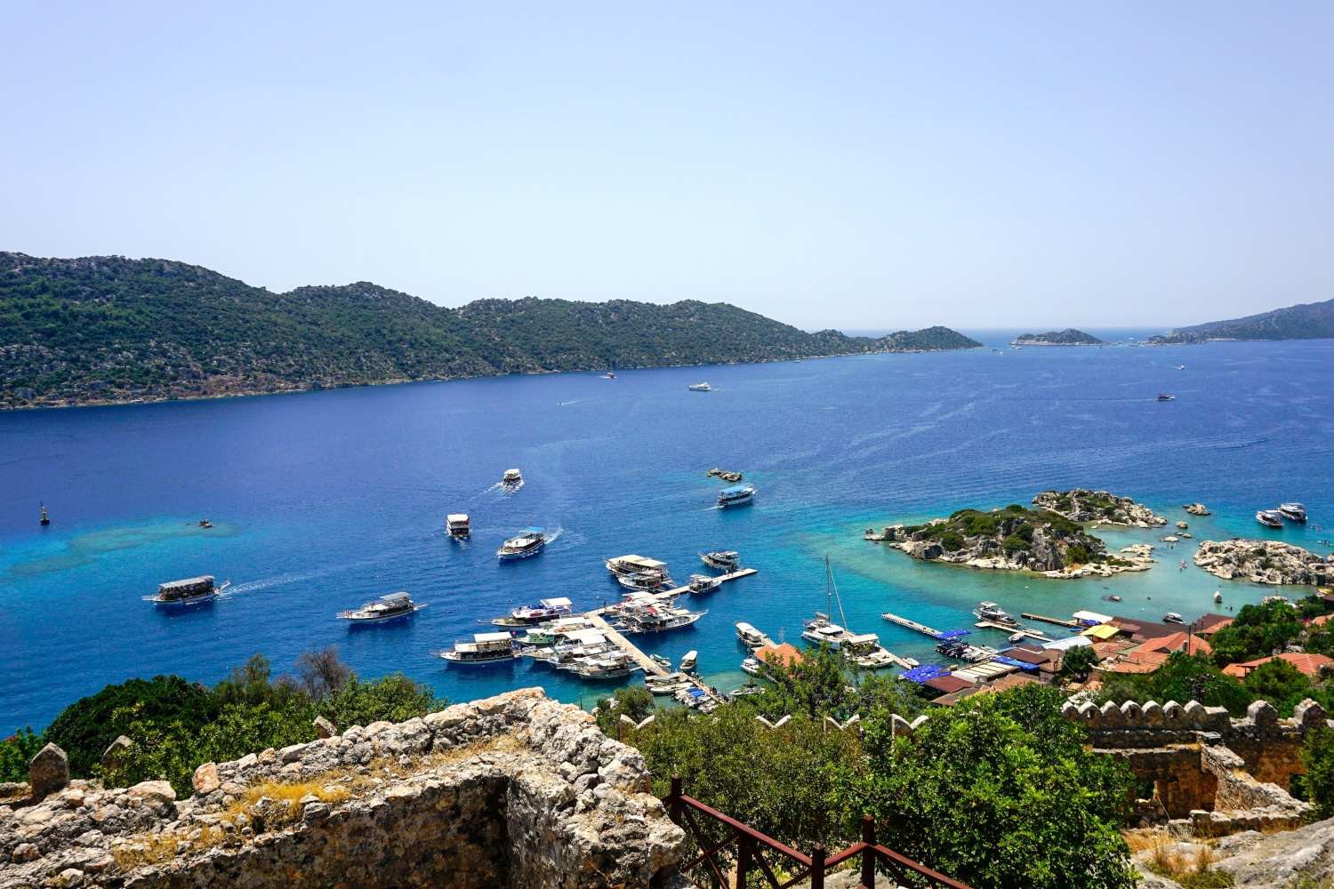 Kekova bay with clear blue water, boats and ancient coastal ruins near Kalkan.