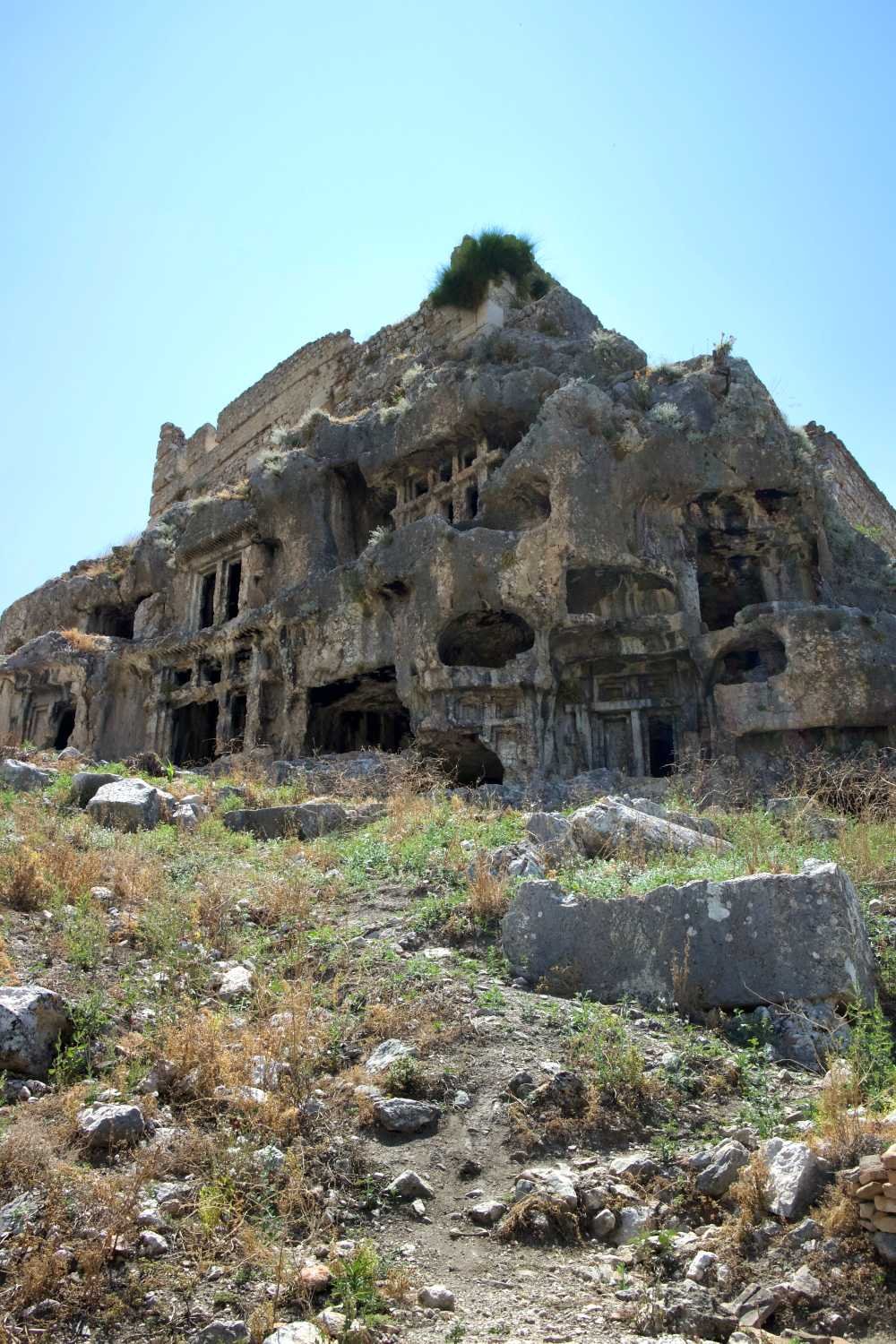 Ancient rock‑cut ruins at Tlos carved into a hillside near Kalkan.